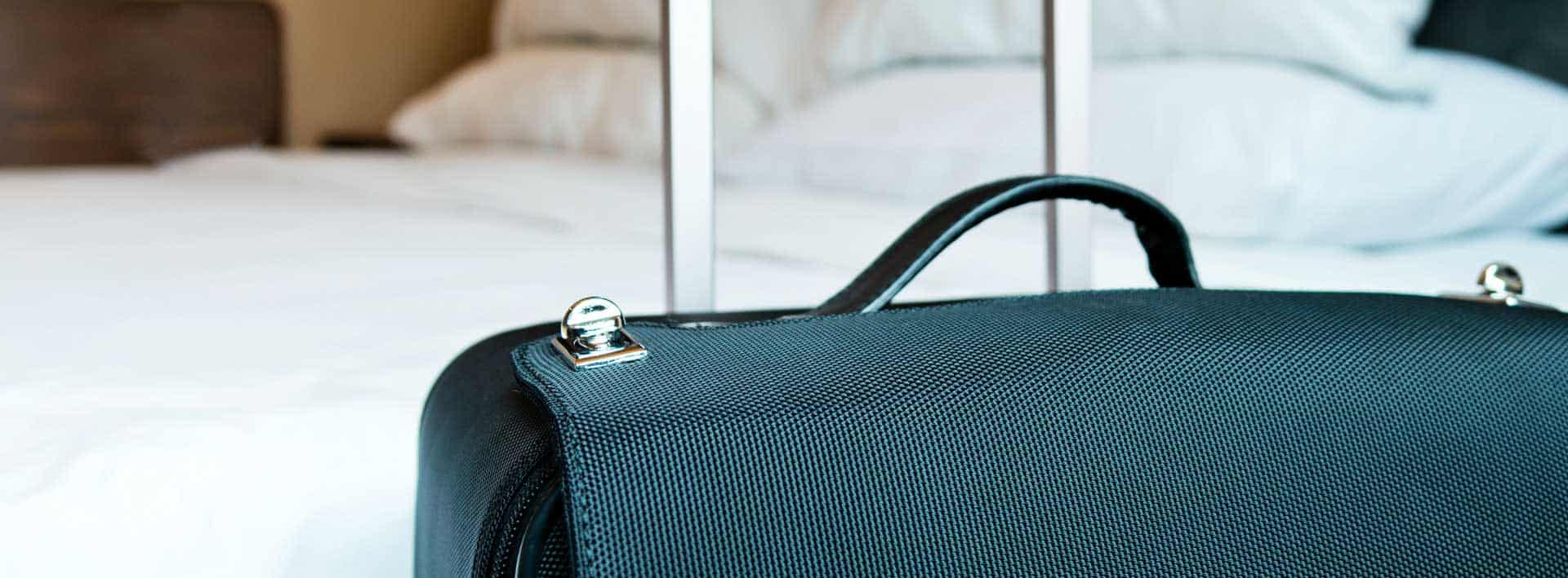 Luggage in hotel room to promote leading hotel insurance brokers Full Time Cover